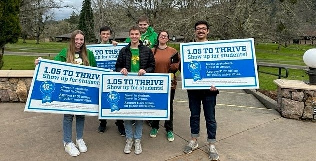 Students hold signs and advocate for the Public University Support Fund