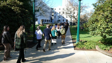 Advocates walk on a path toward the Oregon State Capitol building